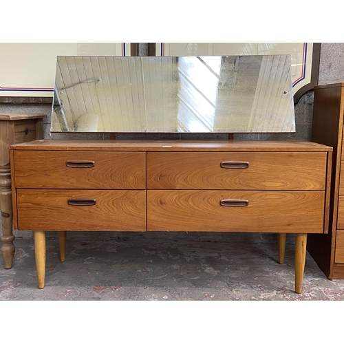 44 - A mid 20th century teak dressing table with upper mirror - approx. 106cm high x 132cm wide x 40cm de... 