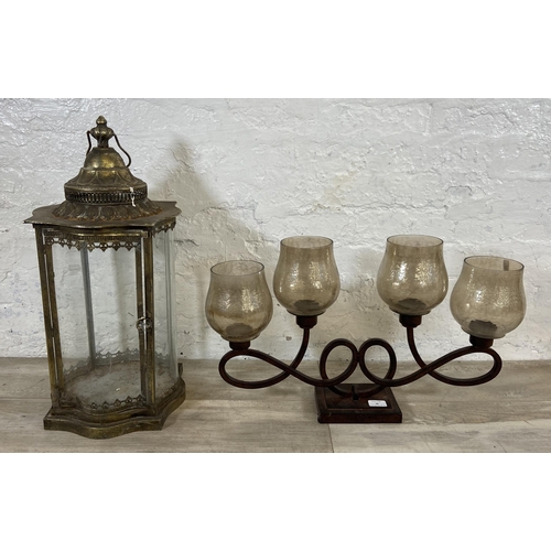 48 - Two items, one wrought metal four branch candelabra and one gilt metal garden lantern - approx. 63cm... 