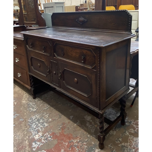 49 - An early 20th century geometric carved and beaded oak sideboard on barley twist supports - approx. 1... 