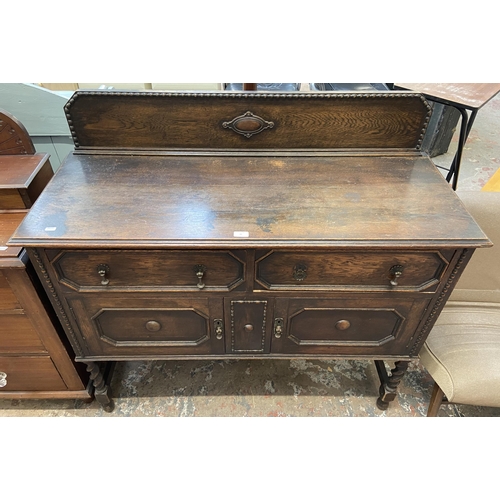 49 - An early 20th century geometric carved and beaded oak sideboard on barley twist supports - approx. 1... 