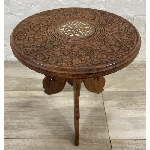 5 - An Indian carved and inlaid teak circular side table - approx. 33cm high x 31cm diameter