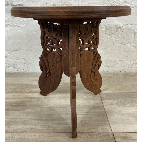 5 - An Indian carved and inlaid teak circular side table - approx. 33cm high x 31cm diameter