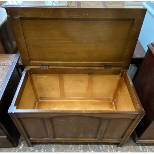 52 - A mid 20th century oak three panel blanket box - approx. 61cm high x 89cm wide x 49cm deep