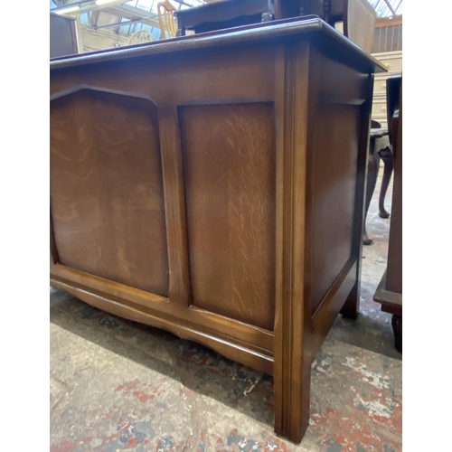 52 - A mid 20th century oak three panel blanket box - approx. 61cm high x 89cm wide x 49cm deep