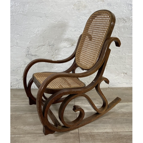 59 - A Thonet style bentwood and rattan child's rocking chair - approx. 70cm high x 36cm wide x 60cm deep