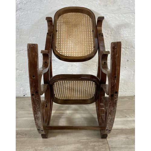 59 - A Thonet style bentwood and rattan child's rocking chair - approx. 70cm high x 36cm wide x 60cm deep