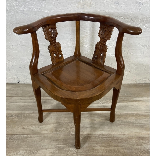 7 - An Oriental carved hardwood corner chair - approx. 71cm high x 62cm wide x 52cm deep