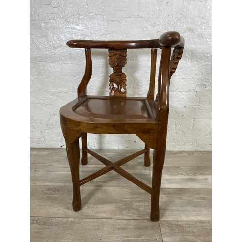 7 - An Oriental carved hardwood corner chair - approx. 71cm high x 62cm wide x 52cm deep