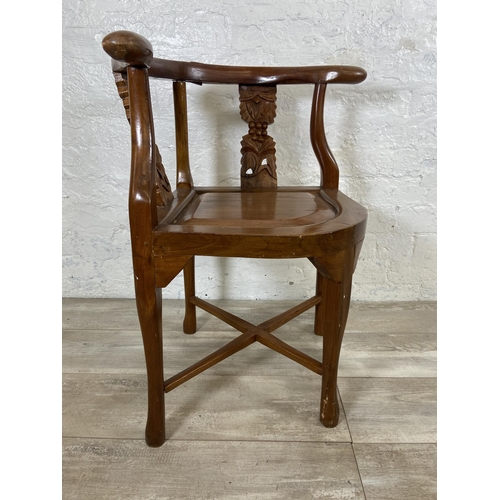 7 - An Oriental carved hardwood corner chair - approx. 71cm high x 62cm wide x 52cm deep