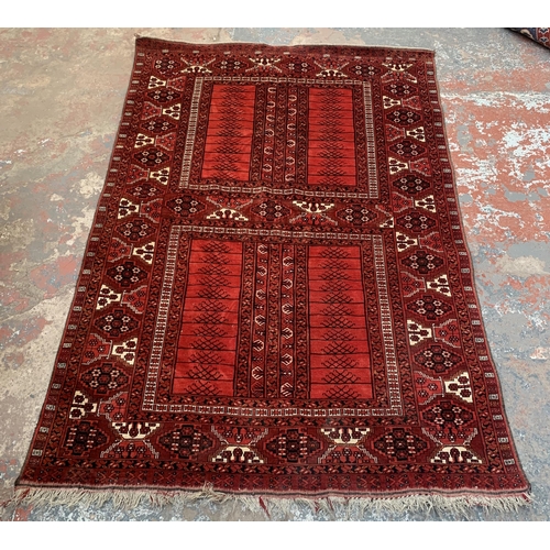 8 - A Persian red ground machine woven rug - approx. 240cm x 156cm