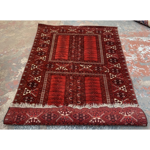 8 - A Persian red ground machine woven rug - approx. 240cm x 156cm