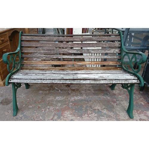 86 - A cast iron and wooden slatted garden bench