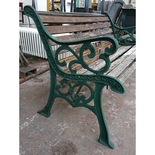 86 - A cast iron and wooden slatted garden bench