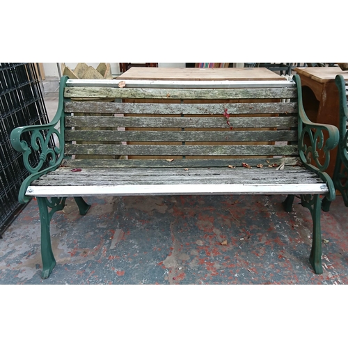 95 - A cast iron and wooden slatted garden bench