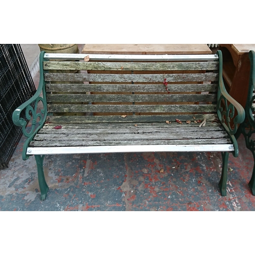 95 - A cast iron and wooden slatted garden bench