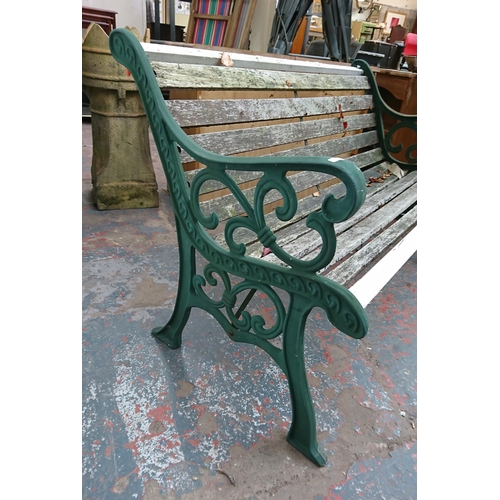 95 - A cast iron and wooden slatted garden bench