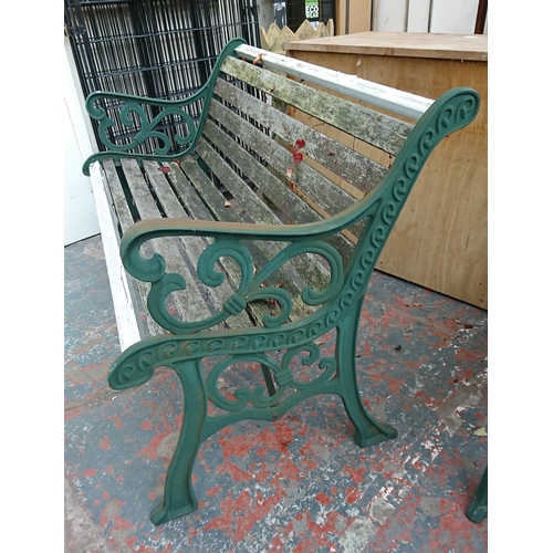 95 - A cast iron and wooden slatted garden bench