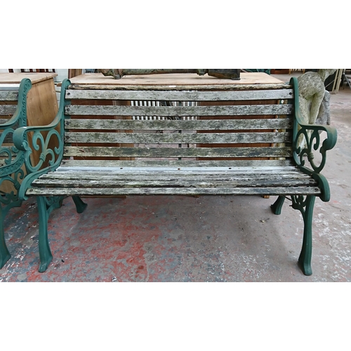 96 - A cast iron and wooden slatted garden bench