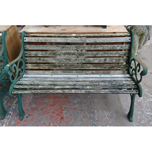 96 - A cast iron and wooden slatted garden bench