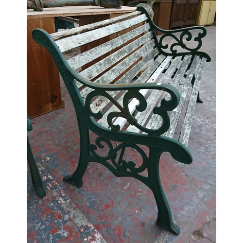 96 - A cast iron and wooden slatted garden bench