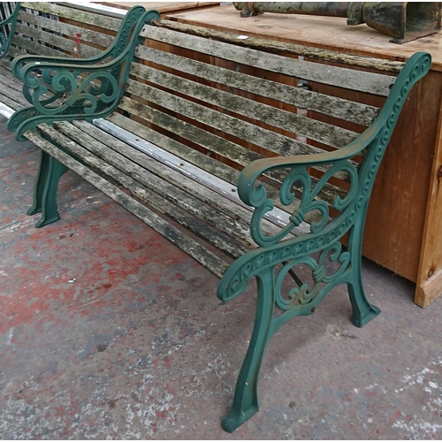 96 - A cast iron and wooden slatted garden bench