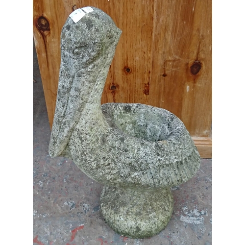 97 - A cast stone pelican garden planter - approx. 56cm high