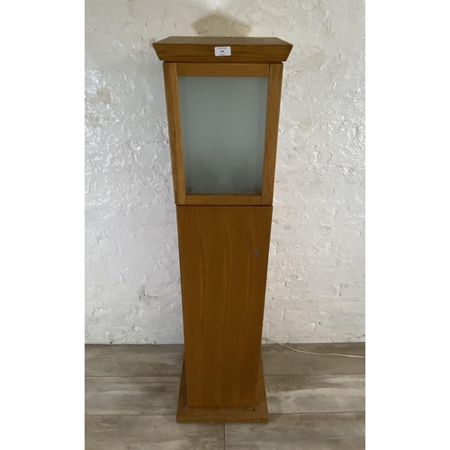 151 - A modern oak illuminating cabinet - approx. 149cm high x 40cm wide x 40cm deep