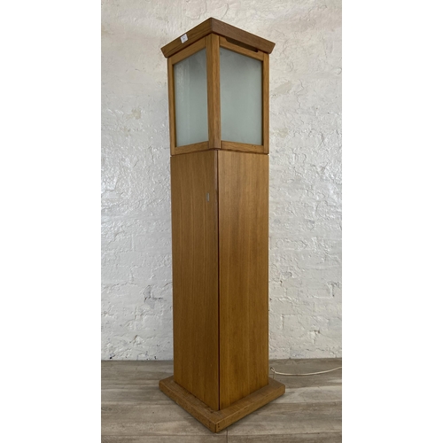 151 - A modern oak illuminating cabinet - approx. 149cm high x 40cm wide x 40cm deep