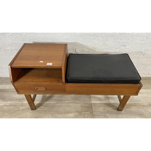 154 - A mid 20th century teak telephone table with black vinyl cushion - approx. 54cm high x 100cm wide x ... 