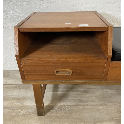 154 - A mid 20th century teak telephone table with black vinyl cushion - approx. 54cm high x 100cm wide x ... 