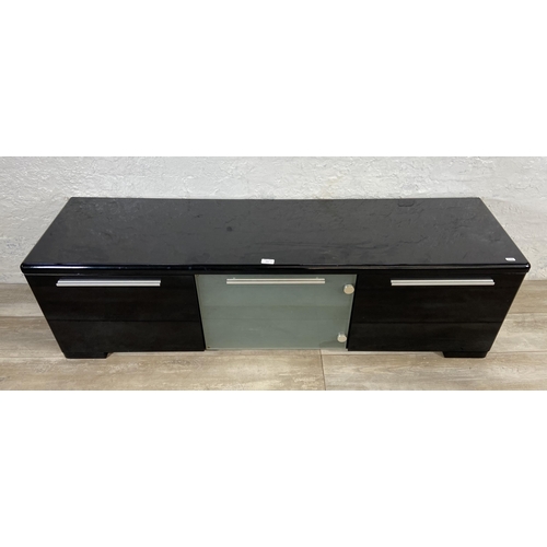 155 - A modern black laminate TV stand - approx. 43cm high x 148cm wide x 40cm deep