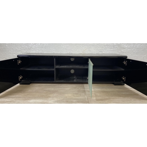 155 - A modern black laminate TV stand - approx. 43cm high x 148cm wide x 40cm deep