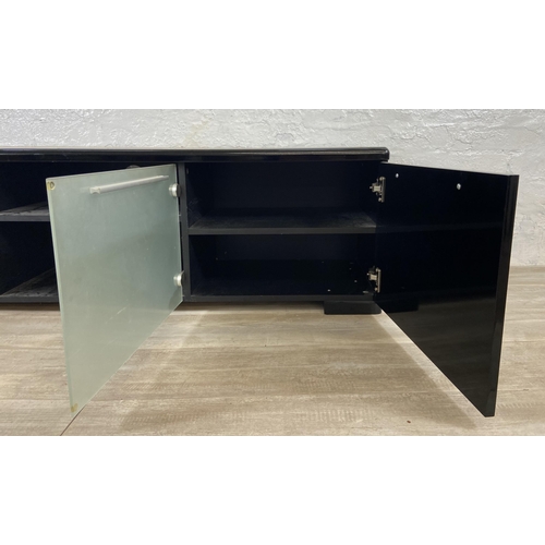 155 - A modern black laminate TV stand - approx. 43cm high x 148cm wide x 40cm deep