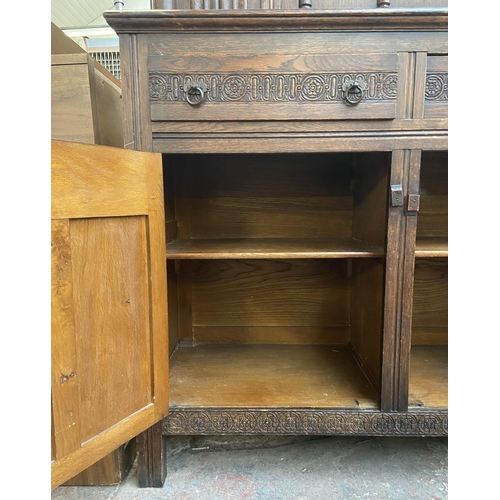 160 - A 17th century style carved oak court cupboard - approx. 153cm high x 121cm wide x 48cm deep