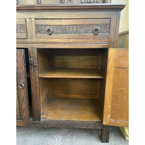 160 - A 17th century style carved oak court cupboard - approx. 153cm high x 121cm wide x 48cm deep