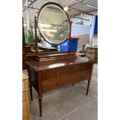 162 - An Edwardian inlaid mahogany dressing table on tapering supports with upper circular bevelled edge m... 