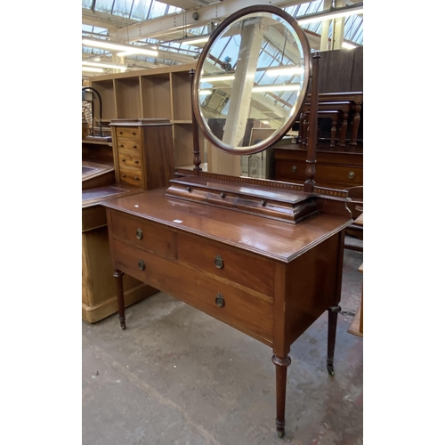 162 - An Edwardian inlaid mahogany dressing table on tapering supports with upper circular bevelled edge m... 