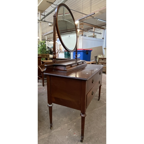 162 - An Edwardian inlaid mahogany dressing table on tapering supports with upper circular bevelled edge m... 