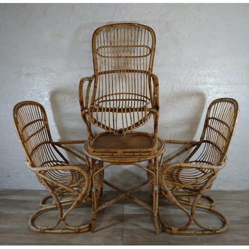 165 - A mid 20th century wicker and bamboo four piece dining suite comprising circular table and three arm... 