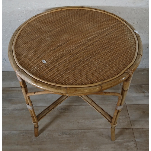 165 - A mid 20th century wicker and bamboo four piece dining suite comprising circular table and three arm... 