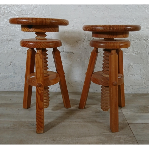 166 - A pair of pine circular top height adjustable stools