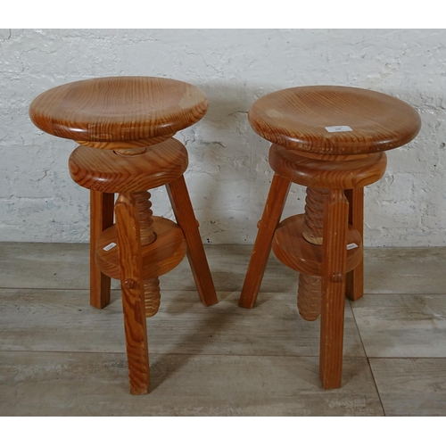 166 - A pair of pine circular top height adjustable stools