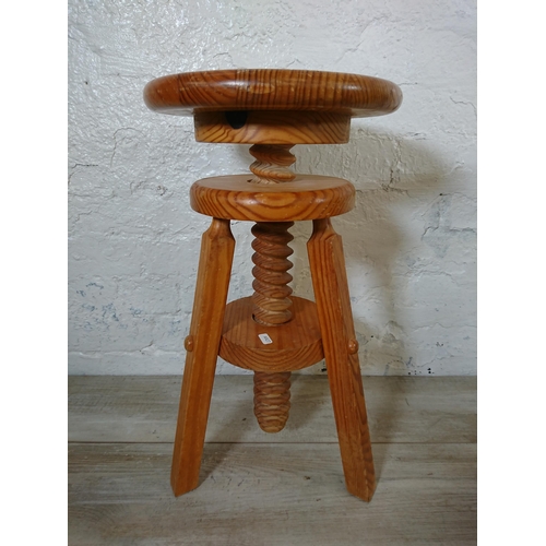 166 - A pair of pine circular top height adjustable stools