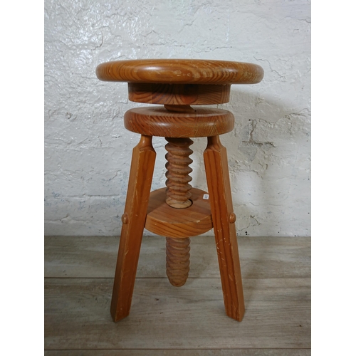 166 - A pair of pine circular top height adjustable stools