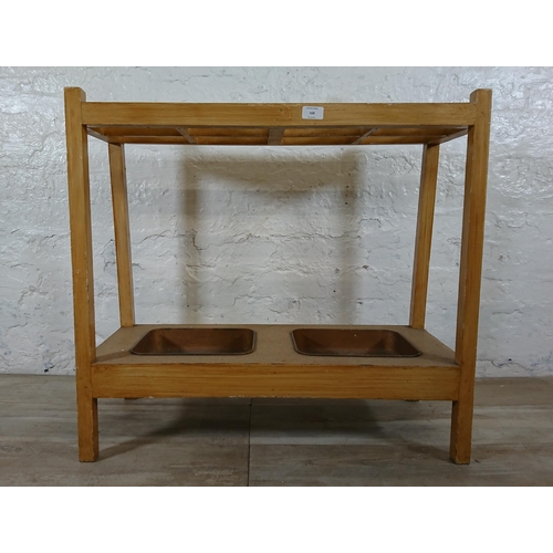 168 - A mid 20th century beech eight section stick stand with two metal drip trays - approx. 71cm high x 7... 