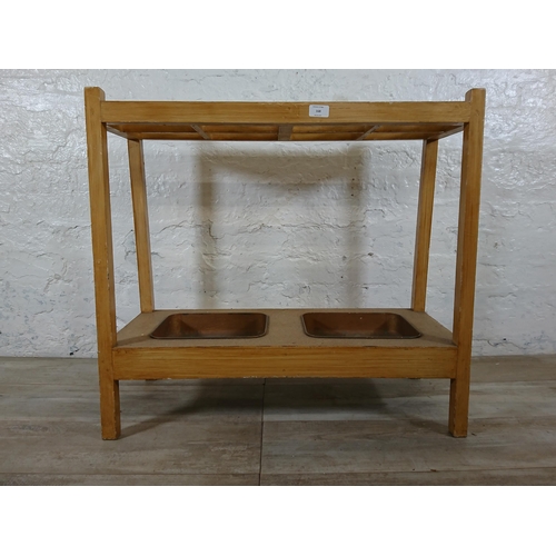 168 - A mid 20th century beech eight section stick stand with two metal drip trays - approx. 71cm high x 7... 