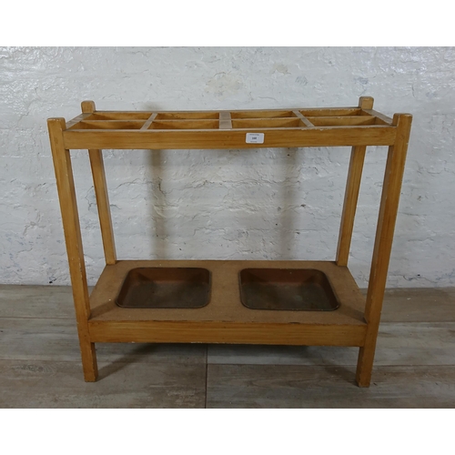 168 - A mid 20th century beech eight section stick stand with two metal drip trays - approx. 71cm high x 7... 