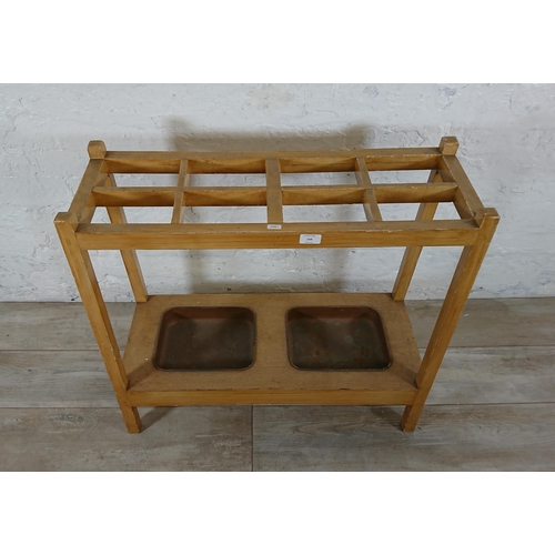 168 - A mid 20th century beech eight section stick stand with two metal drip trays - approx. 71cm high x 7... 