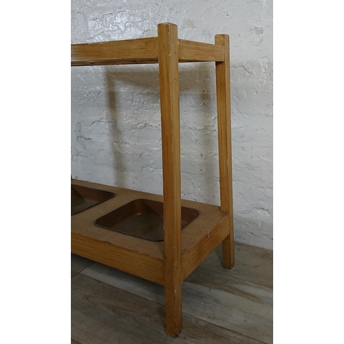 168 - A mid 20th century beech eight section stick stand with two metal drip trays - approx. 71cm high x 7... 