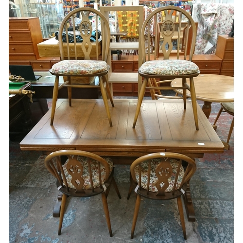 173 - An Ercol Golden Dawn elm draw leaf dining table and four Fleur De Lys chairs - table approx. 75cm hi... 